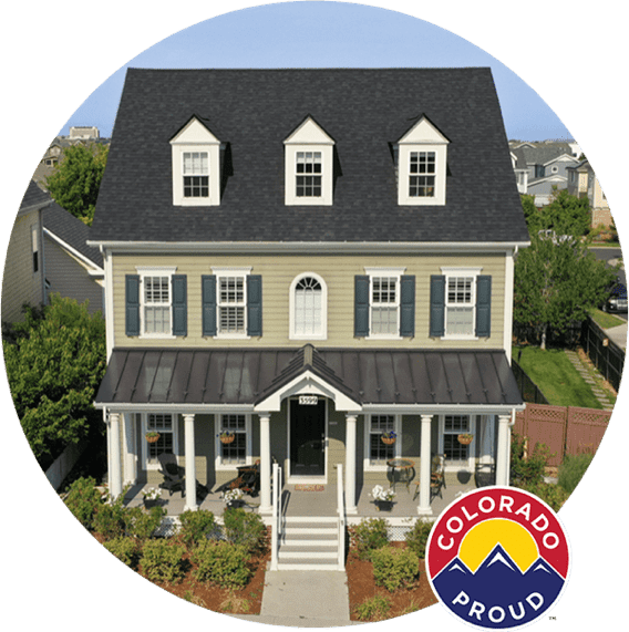Tan house with black asphalt shingle roof and black metal porch roof with Colorado Proud logo